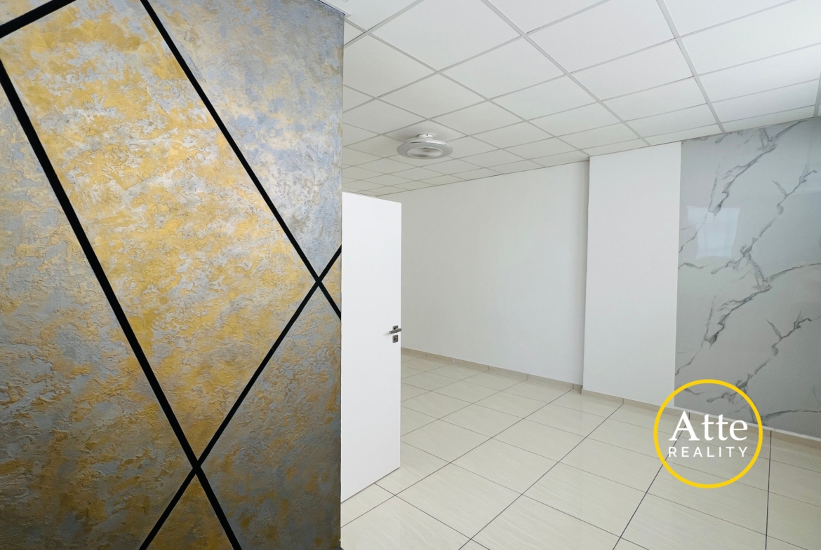 Interior showroom scene featuring a large textured wall panel in gold and blue with black diagonal lines, a white door, and tiled floor.